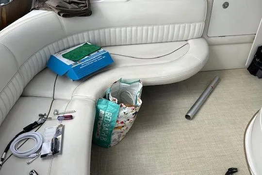 Slide: The Image of Interior of a 2000 Cruisers 3575 boat with white seating and various items. - 9