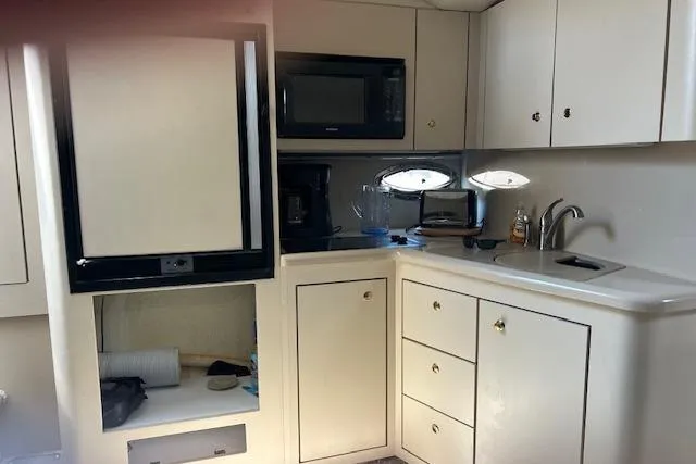 Slide: The Image of 2000 Cruisers 3575 yacht kitchen with cabinets, sink, and appliances. - 12