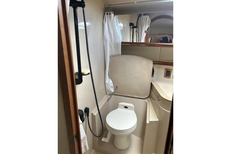 Slide: The Image of 2000 Cruisers 3575 yacht bathroom with shower, toilet, and mirror. - 17