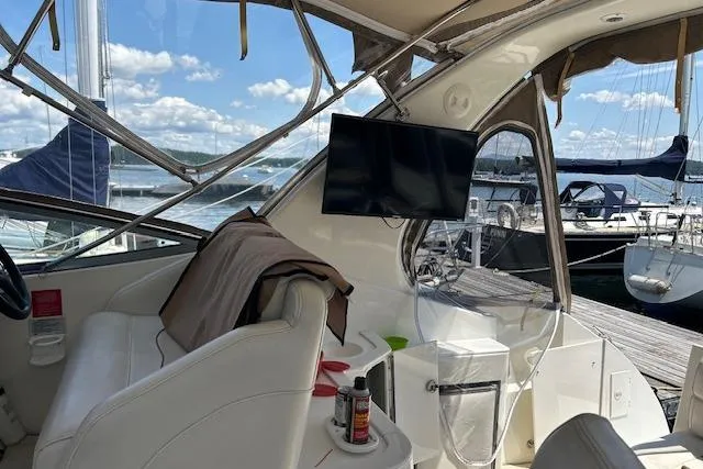 Slide: The Image of 2000 Cruisers 3575 yacht interior with seating, TV, and marina view. - 7