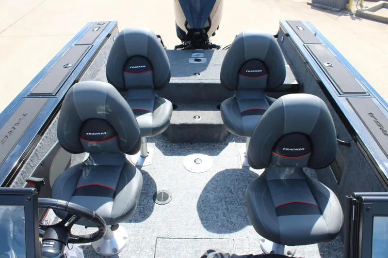 Slide: The Image of 2026 Tracker Targa V-18 Combo boat interior with four gray seats. - 12