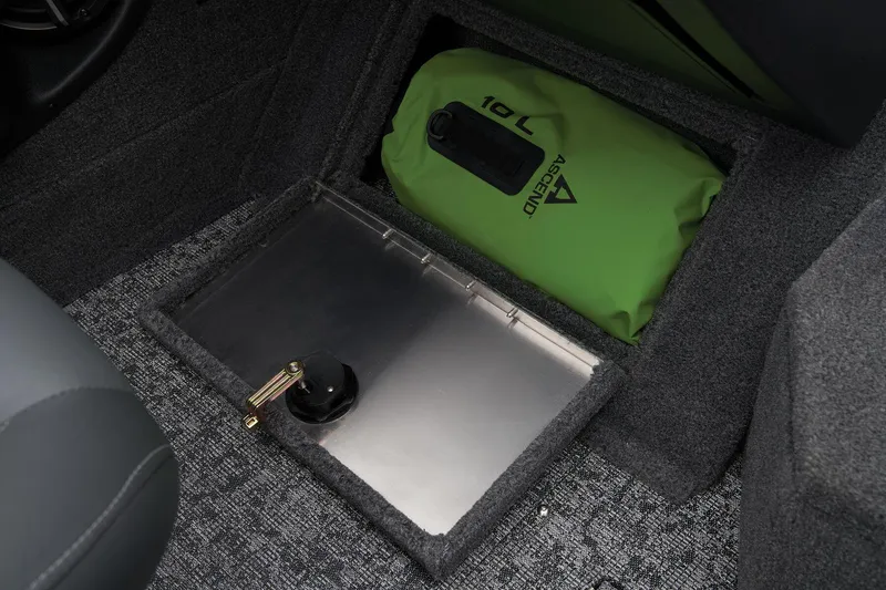 Slide: The Image of Manufacturer Provided Image: Storage compartment in 2026 Tracker Targa V-18 Combo with green 10L dry bag. - 56