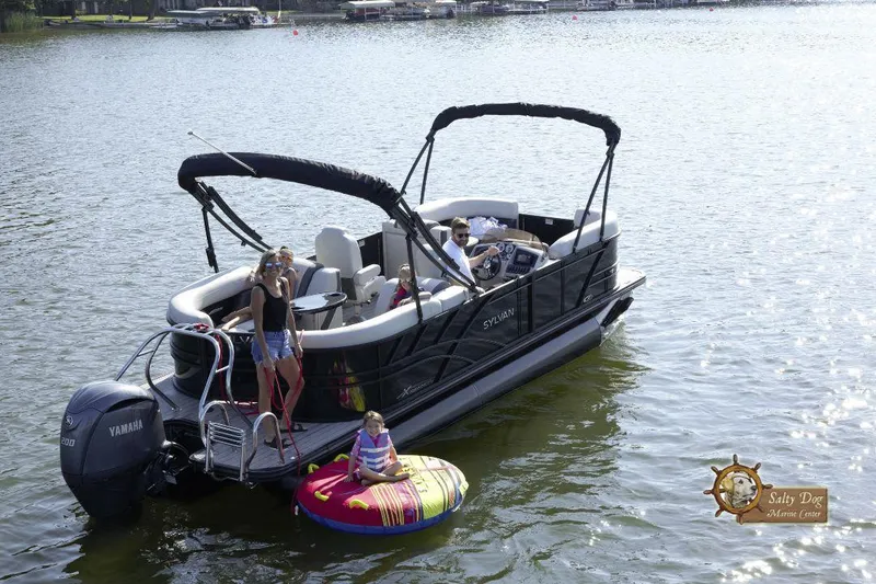 Slide: The Image of 2026 Sylvan Mirage X3 boat interior with seating and privacy curtain. - 10