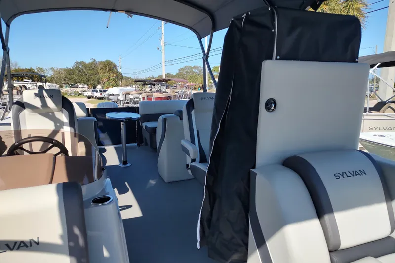 Slide: The Image of 2026 Sylvan Mirage X3 boat interior with seating and steering wheel. - 16