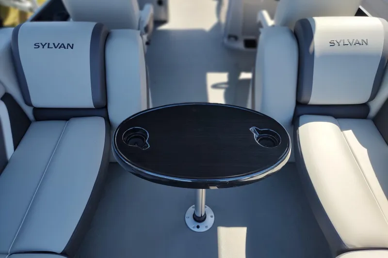Slide: The Image of 2026 Sylvan Mirage X3 boat interior with sleek seating and a central table. - 17
