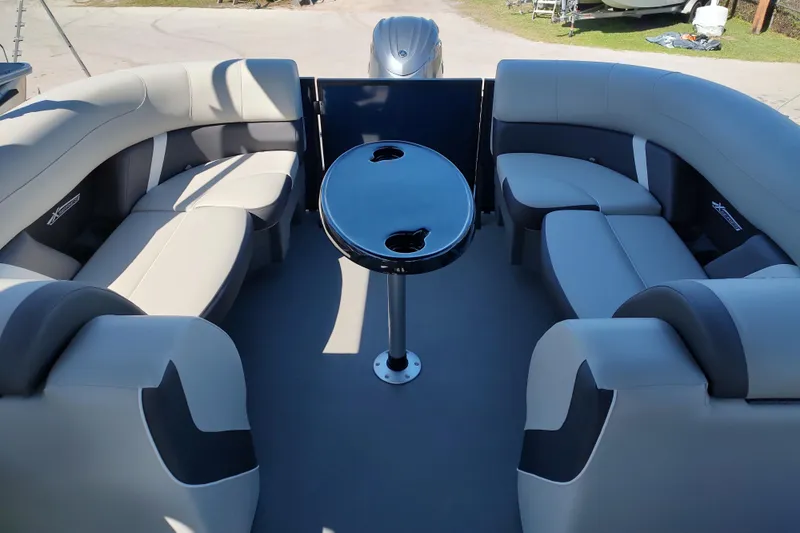 Slide: The Image of Luxurious interior of 2026 Sylvan Mirage X3 pontoon boat with plush seating and table. - 18
