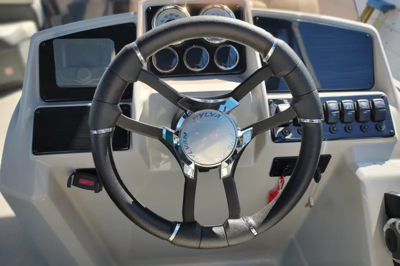 Slide: The Image of Steering wheel of 2026 Sylvan Mirage X3 boat with control panel and gauges. - 20