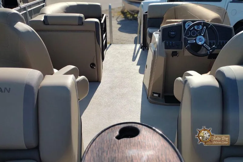 Slide: The Image of 2026 Sylvan Mirage X3 pontoon boat with canopy, displayed on a trailer. - 3