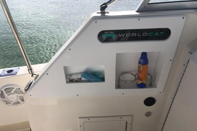 Slide: The Image of 1998 World Cat 266 SC boat interior with storage compartments and ocean view. - 13