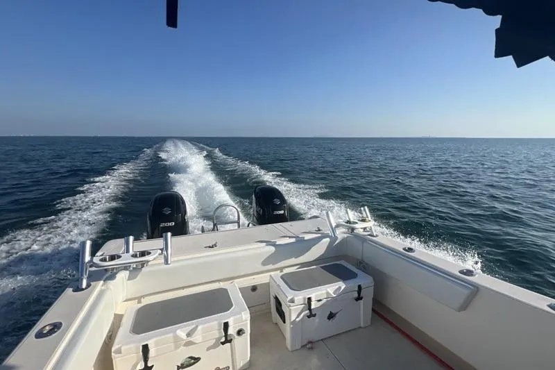 Slide: The Image of 1998 World Cat 266 SC boat cruising on open water, leaving a wake behind. - 14