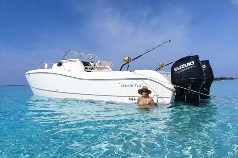 Slide: The Image of 1998 World Cat 266 SC boat with Suzuki engines in clear blue water. - 3