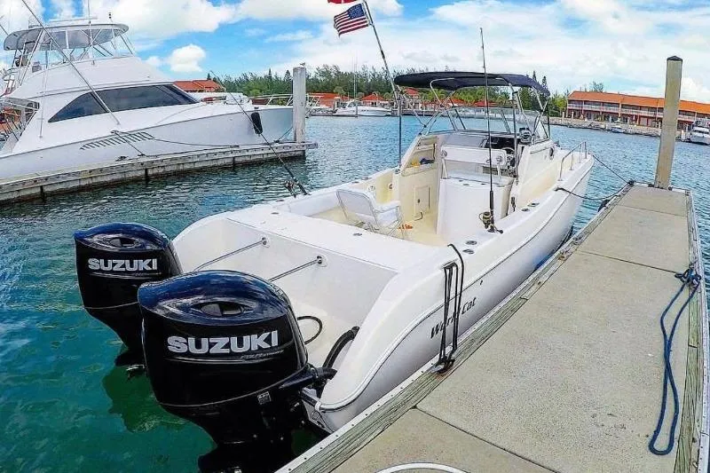 Slide: The Image of 1998 World Cat 266 SC boat docked with dual Suzuki outboard motors. - 7
