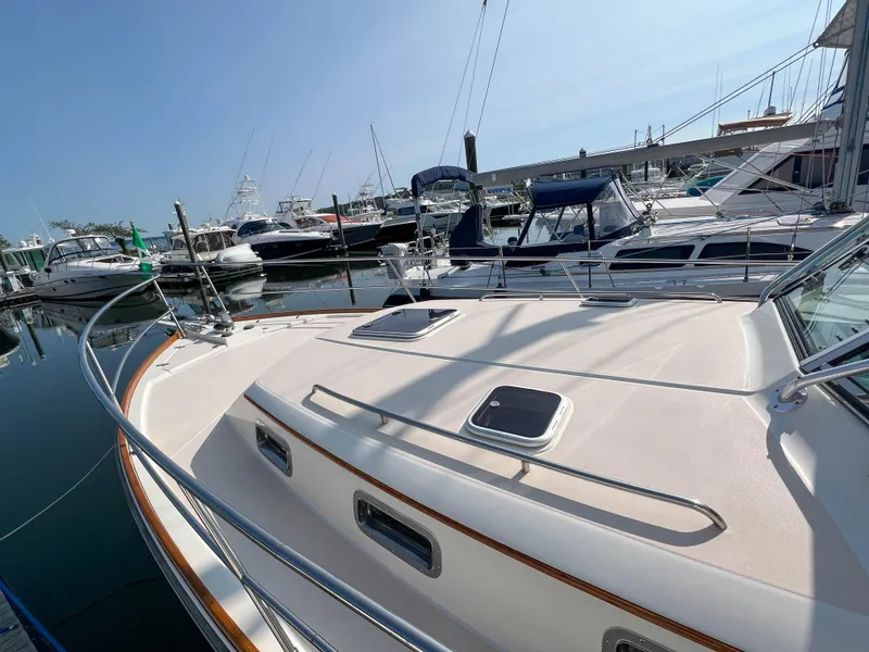 Slide: The Image of 2001 Sabre 36 Express yacht docked in marina, surrounded by other boats. - 10