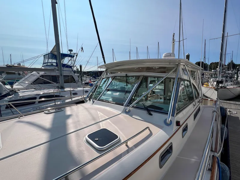 Slide: The Image of 2001 Sabre 36 Express yacht docked at marina, showcasing sleek design and spacious deck. - 11