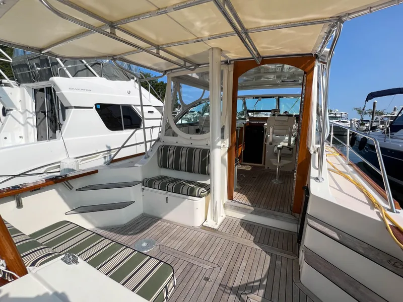 Slide: The Image of 2001 Sabre 36 Express yacht with striped seating and spacious deck area. - 15