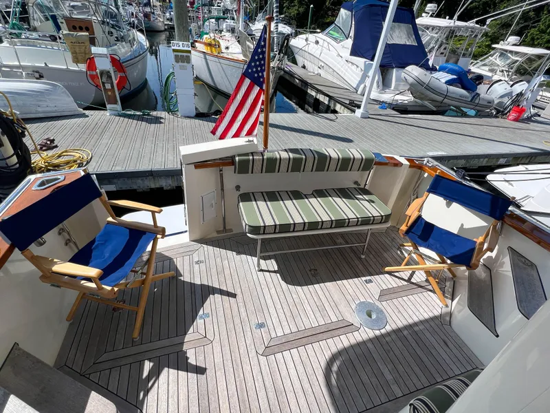 Slide: The Image of 2001 Sabre 36 Express yacht with seating area and American flag at marina. - 16