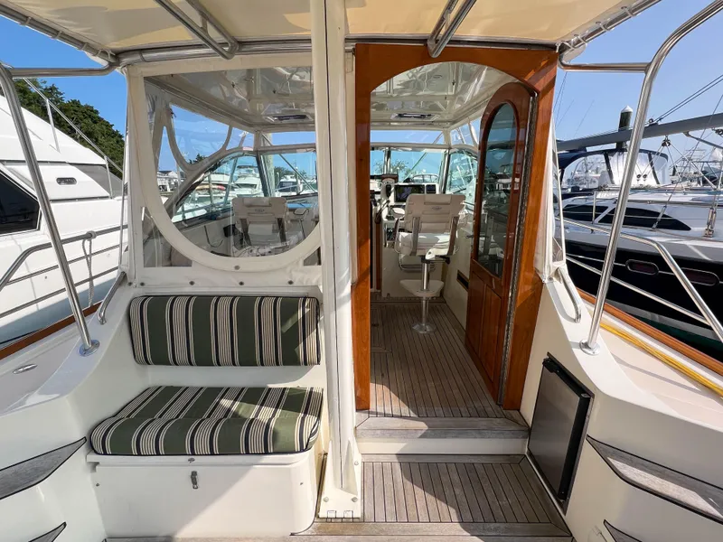 Slide: The Image of 2001 Sabre 36 Express yacht interior with striped seating and wooden accents. - 18