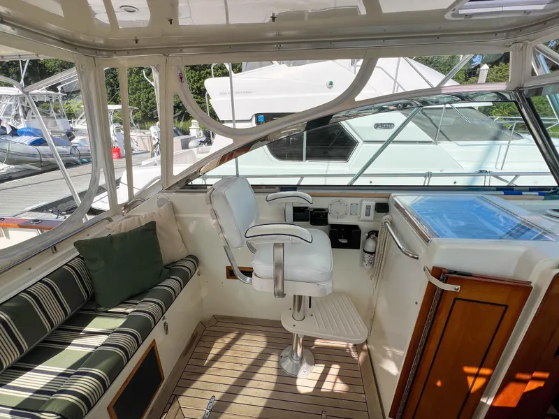 Slide: The Image of 2001 Sabre 36 Express yacht interior with helm seat and striped bench. - 22