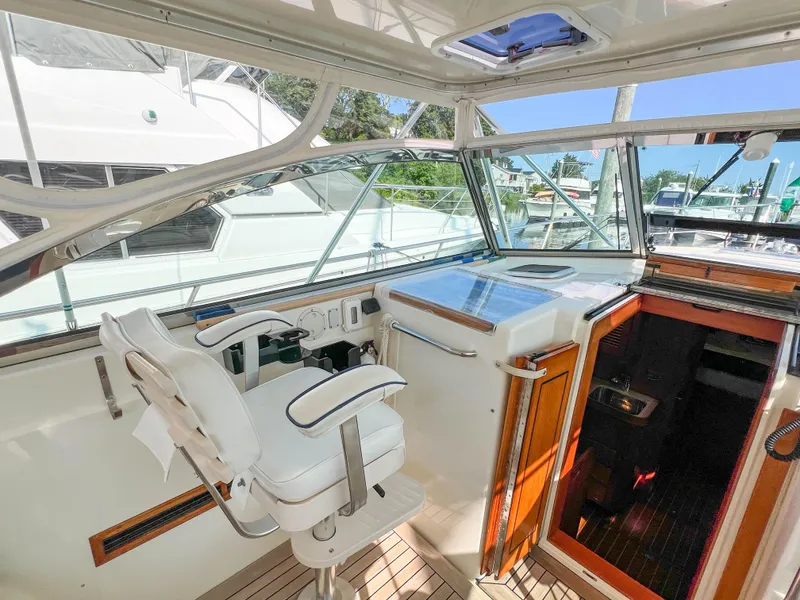 Slide: The Image of Interior of 2001 Sabre 36 Express yacht, featuring helm station and captain's chair. - 23