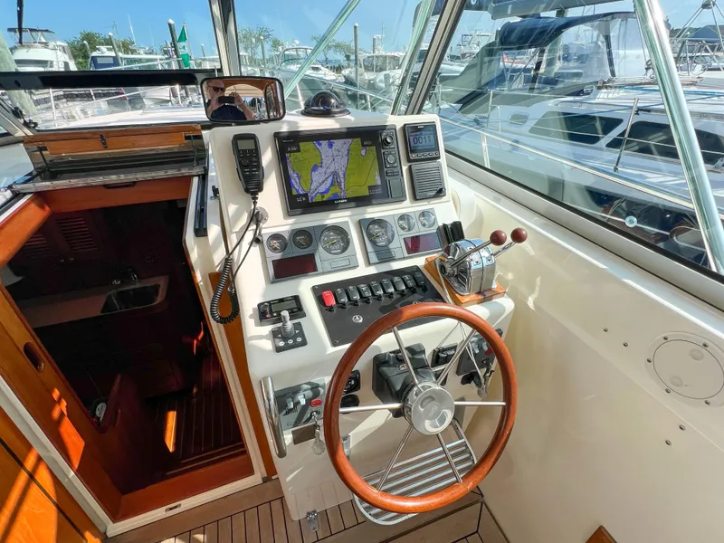Slide: The Image of 2001 Sabre 36 Express helm with navigation equipment and wooden steering wheel. - 26