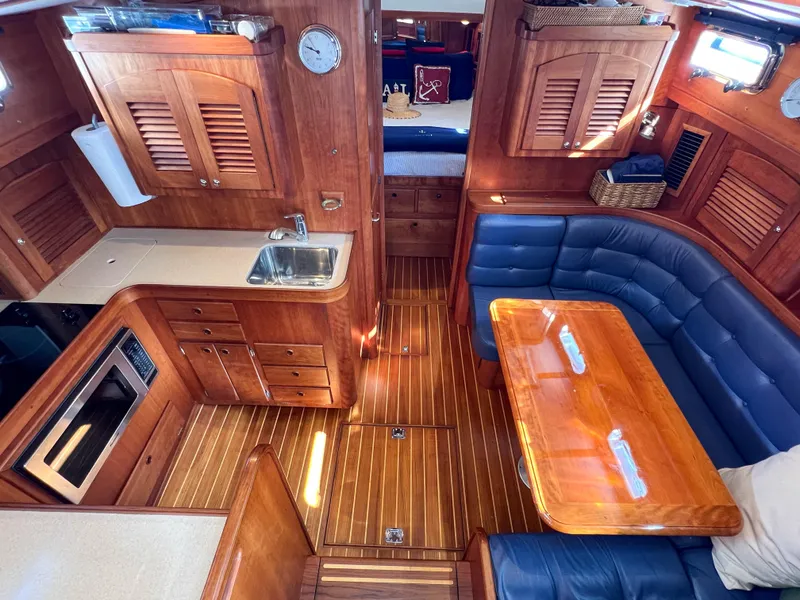 Slide: The Image of Interior of 2001 Sabre 36 Express yacht with wood finish and blue seating. - 30