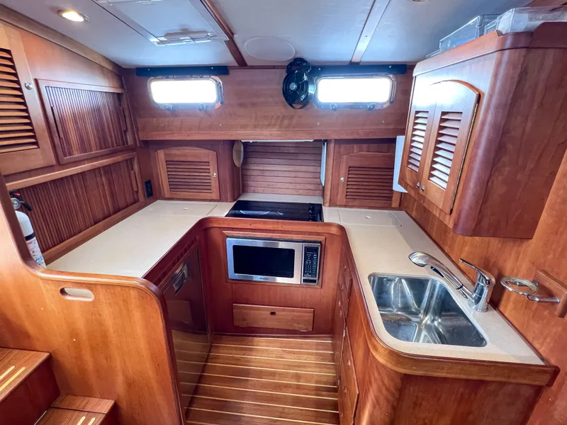 Slide: The Image of 2001 Sabre 36 Express yacht kitchen with wood cabinetry and modern appliances. - 35