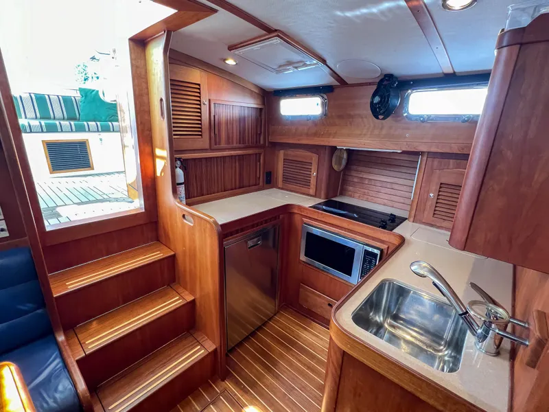 Slide: The Image of Interior of 2001 Sabre 36 Express yacht with wooden cabinetry and modern kitchen amenities. - 36