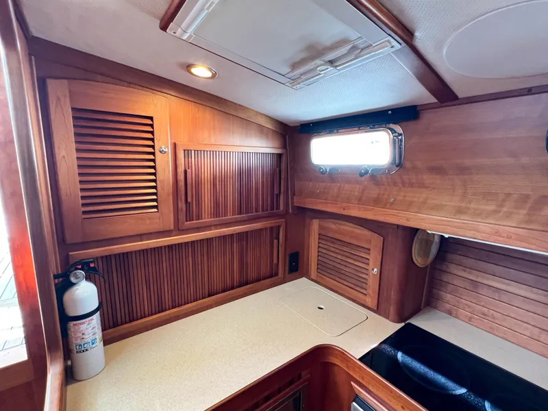 Slide: The Image of 2001 Sabre 36 Express cabin interior with wood paneling and countertop. - 38