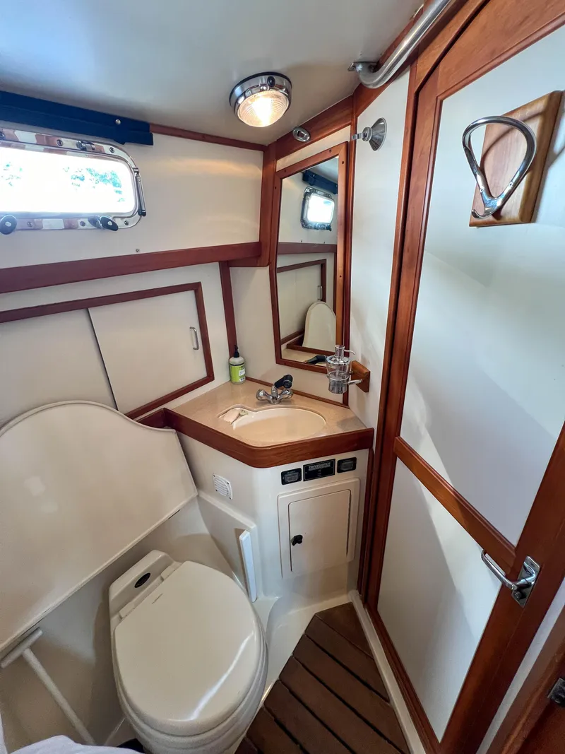 Slide: The Image of 2001 Sabre 36 Express yacht bathroom with wood accents and compact design. - 44