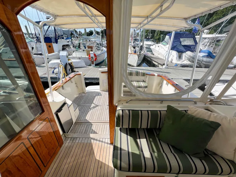 Slide: The Image of Interior view of 2001 Sabre 36 Express yacht with striped seating and marina backdrop. - 47