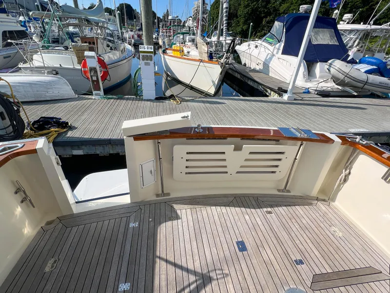 Slide: The Image of 2001 Sabre 36 Express yacht docked at marina with wooden deck and surrounding boats. - 49