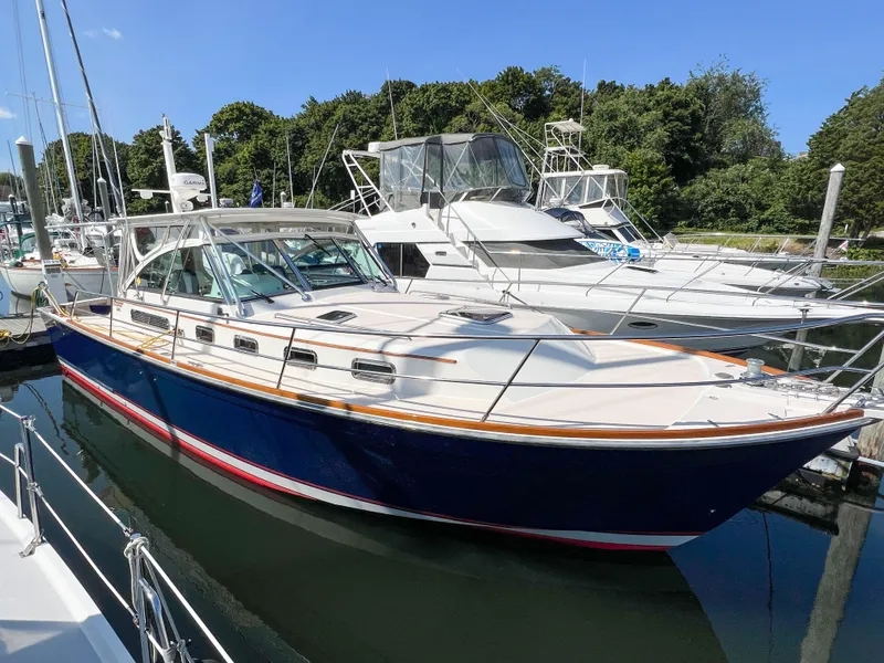 Slide: The Image of 2001 Sabre 36 Express yacht docked at marina, blue hull, white deck, sunny day. - 6