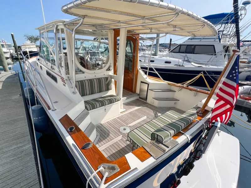 Slide: The Image of 2001 Sabre 36 Express boat with striped seating, docked at marina. - 8