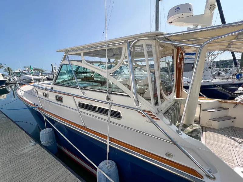 Slide: The Image of 2001 Sabre 36 Express yacht docked at marina, featuring sleek design and blue hull. - 9