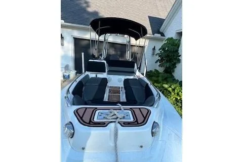 Slide: The Image of 2005 AB Inflatables Nautilus 15 DLX boat with seating and canopy, docked near a house. - 6