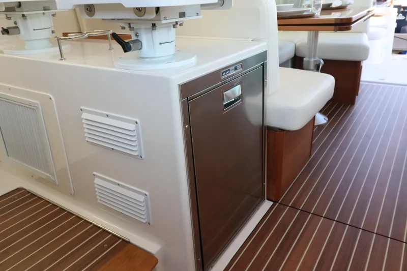 Slide: The Image of 2026 Back Cove 412 yacht interior with seating and stainless steel appliance. - 13