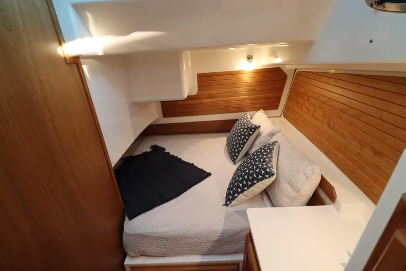Slide: The Image of Cozy cabin interior of 2026 Back Cove 412 yacht with wood paneling and comfortable bedding. - 15