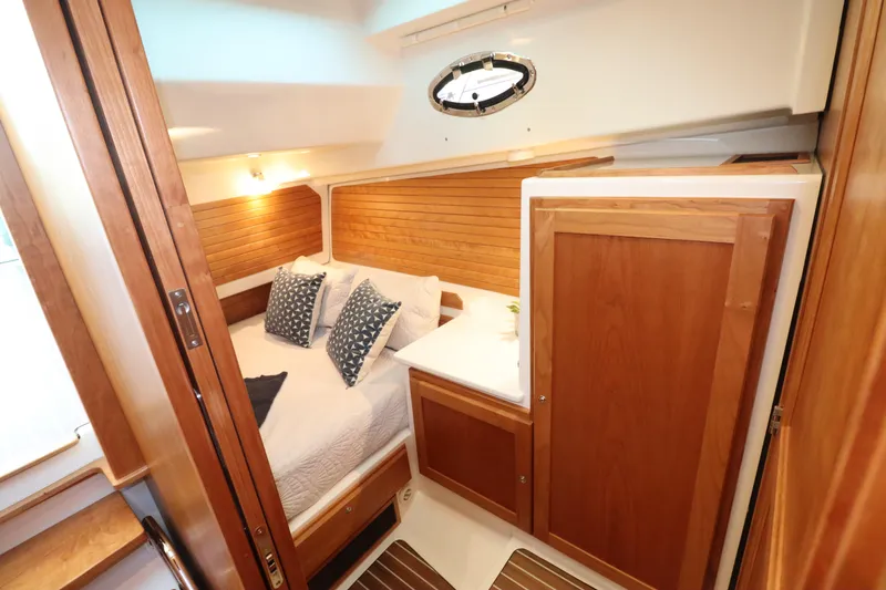 Slide: The Image of Luxurious cabin interior of 2026 Back Cove 412 yacht with wooden accents and cozy bedding. - 16