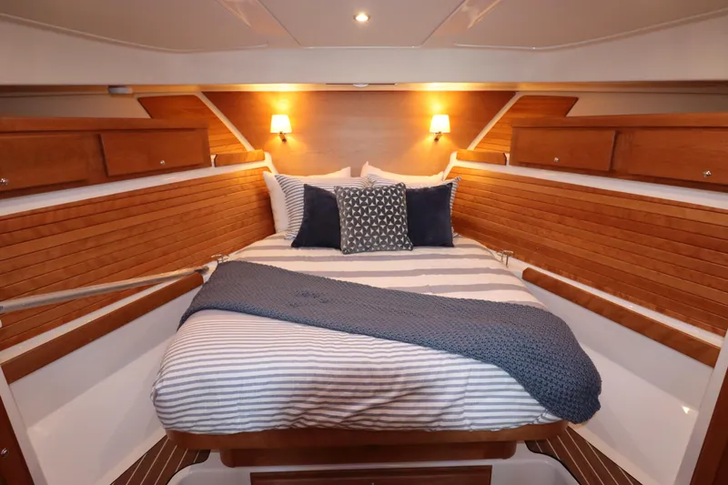Slide: The Image of Luxurious cabin interior of 2026 Back Cove 412 yacht with cozy bedding and wooden accents. - 18