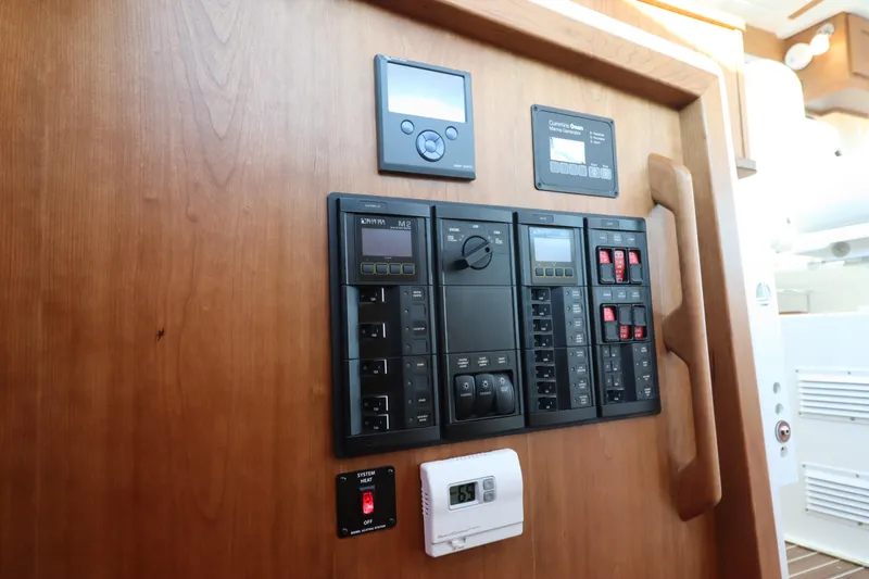 Slide: The Image of Control panel on 2026 Back Cove 412 yacht, featuring various switches and displays. - 20