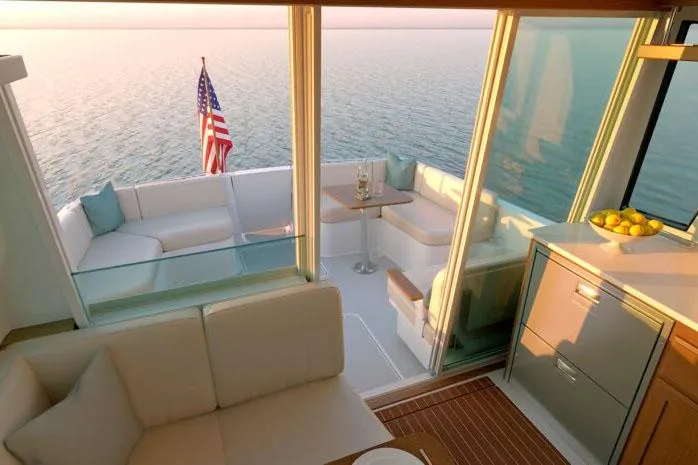 Slide: The Image of 2026 Back Cove 412 boat docked near waterfront buildings, American flag displayed. - 3