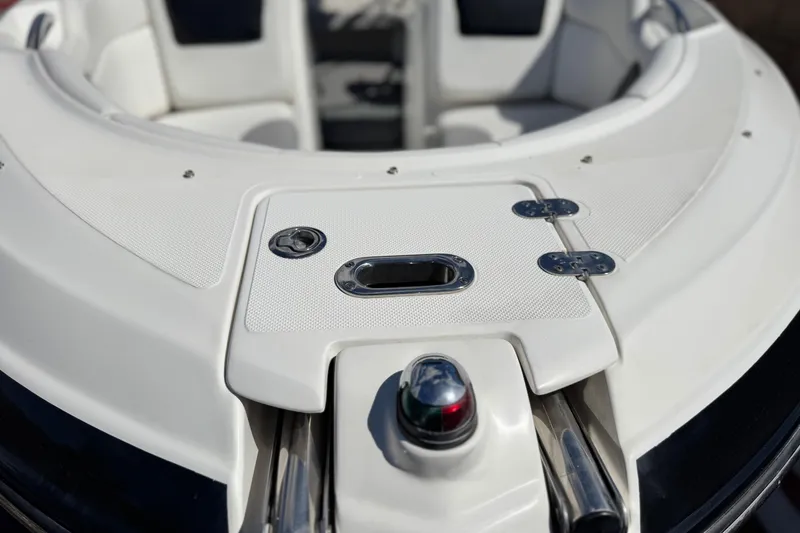 Slide: The Image of 2018 Rinker 23QX BR boat bow with white seating and chrome details. - 12