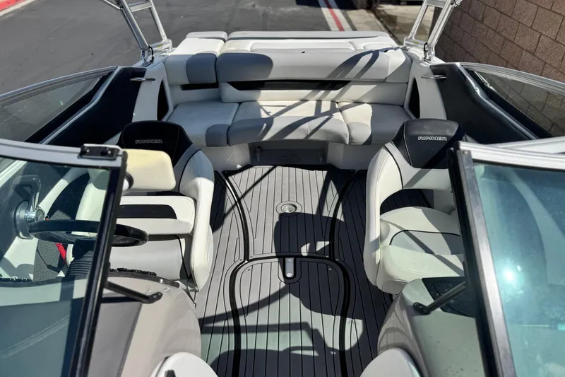 Slide: The Image of 2018 Rinker 23QX BR boat interior with white seating and sleek design. - 17
