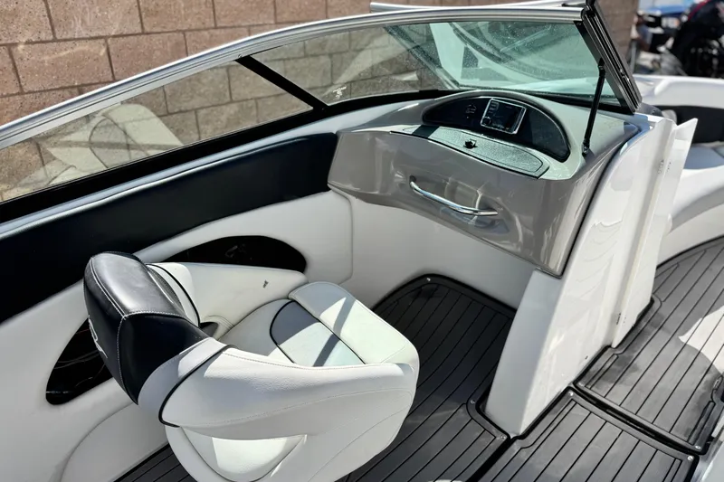 Slide: The Image of 2018 Rinker 23QX BR boat interior with sleek dashboard and comfortable seating. - 20