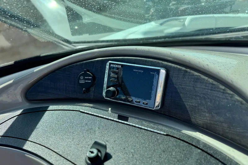Slide: The Image of Dashboard of 2018 Rinker 23QX BR boat with Kicker media center. - 21