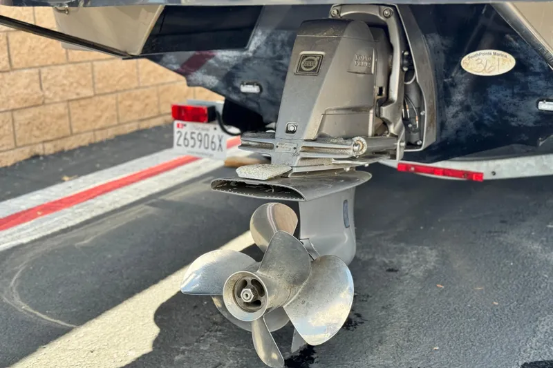 Slide: The Image of 2018 Rinker 23QX BR boat propeller and outdrive close-up. - 7