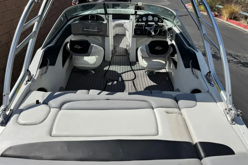Slide: The Image of 2018 Rinker 23QX BR boat interior with seating and dashboard view. - 8