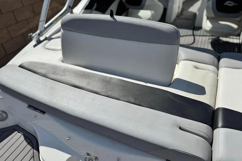 Slide: The Image of 2018 Rinker 23QX BR boat interior with gray and black seating. - 9