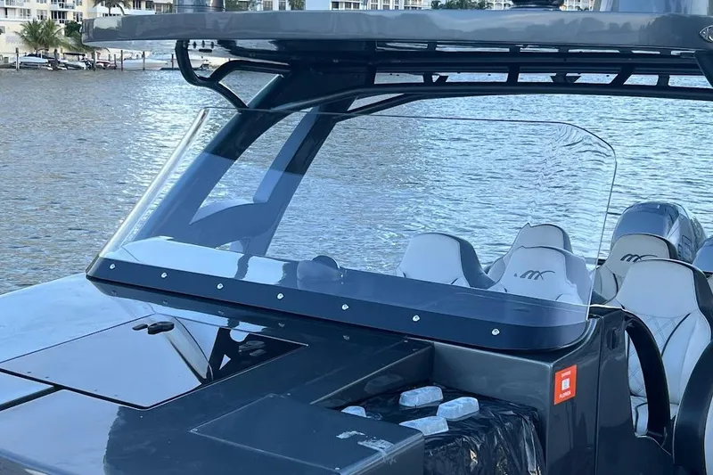 Slide: The Image of 2019 Midnight Express 43 Open boat with sleek design and modern seating on the water. - 13