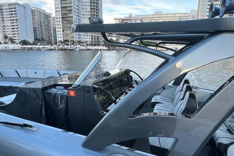 Slide: The Image of 2019 Midnight Express 43 Open boat with sleek design, docked near urban waterfront. - 15